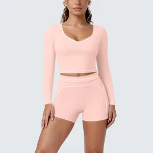 Pink long sleeve crop top and shorts yoga set for women, perfect for fitness and gym workouts.