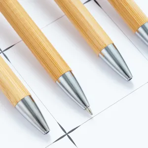 Eco-friendly bamboo ballpoint pen with metallic tip, smooth rotating design for office gifts.