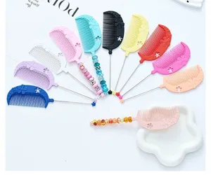 Colorful plastic beaded hair styling comb with flower decor, detail view of parting tools.