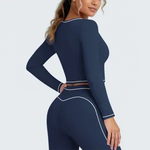 Gedetailleerd overzicht van donkerblauwe sportieve crop top met lange mouwen en broek.