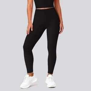 Detail view of high waist stretch black yoga pants showing butt lifting and seamless fabric finish.