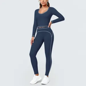 Dark blue seamless long sleeve crop top and high waist yoga leggings set with white piping.