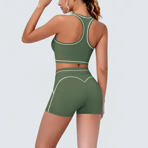 Green two piece yoga set with contrast piping, activewear sports bra and high waist shorts.
