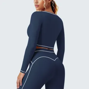 Dunkelblaue langärmlige Sport-Crop-Top mit weißen Kontrastnähten, Detailansicht für Frauen.