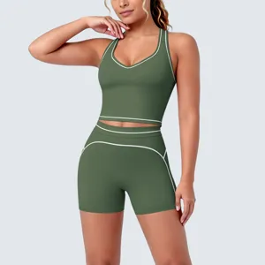 Detail view of the olive green sports bra and fitness shorts set with contrast white piping trim.