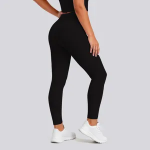 Detail view of black high waist butt lifting fitness yoga pants with white sports sneakers.