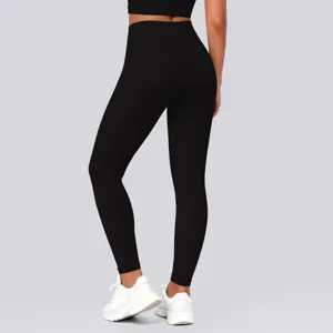 Detailed view of women's black high-waist tight leggings, showing stretch and hip lift fit.