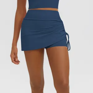 Detailed view of high-waisted ruched athletic yoga skort with built-in shorts for active fitness.