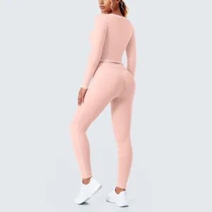 Detail view of pink long sleeve yoga set with white contrast piping for fitness and gym wear.