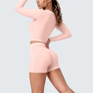 Pink activewear detail view showcasing contrast white piping on a fitted long sleeve crop top.