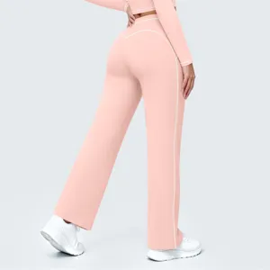 Detail view of the pink wide-leg sports pants showcasing contrast white piping design and back fit.