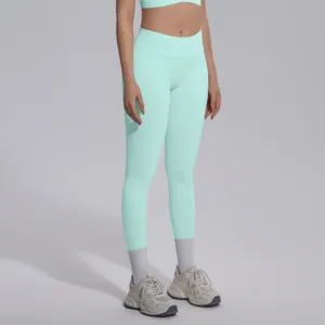 Detailed view of mint green seamless high-waist yoga leggings and sports bra set.