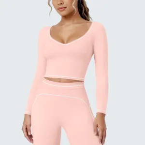 Dames roze lange mouw sport crop top en bijpassende leggings fitness yoga set kleding.