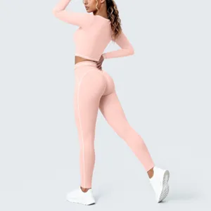 Detailed view of pink long sleeve crop top and leggings fitness set with white contrast piping.