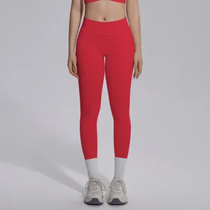 Seamless red yoga leggings detail showing high-waist fit and stretchy breathable fabric.