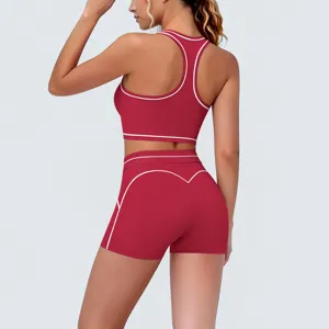 Back detail of red athletic yoga set sports bra and shorts with white contrast trim.