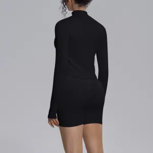 Seamless black long sleeve mock neck sports top and matching fitness shorts set for yoga.