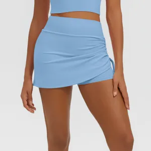 Breathable light blue athletic yoga skort with side gathering and built-in shorts for fitness.
