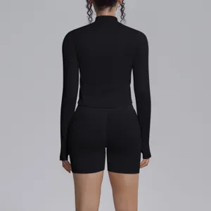 Back detail of black seamless ribbed athletic long sleeve top and shorts activewear set.