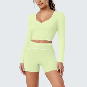 Detailed close-up view of the light green athletic crop top and shorts set, showcasing stretchy fabric.
