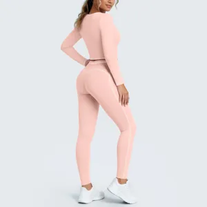 Pink long sleeve crop top and high waist leggings activewear set detail view for fitness training.