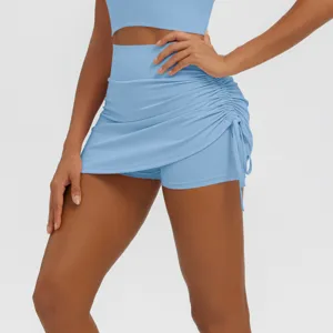 Close-up of light blue athletic yoga skort with side drawstring and pleated design.
