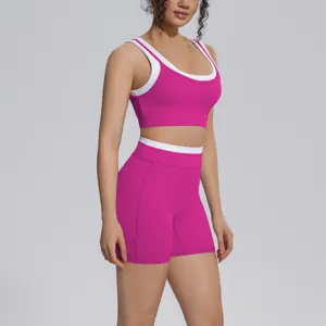 Pink contrast color activewear two-piece set, sports bra and tight yoga shorts detail.