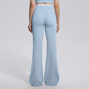 Pantalon de yoga évasé taille haute femme vue arrière, collant de sport bleu clair.