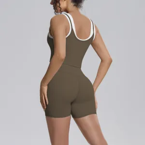 Detail view of women two-piece yoga set, contrast color backless tank top and tight shorts.
