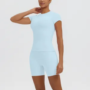 Détail du haut de yoga respirant bleu clair et du short de sport ajusté à taille haute.