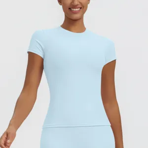 Close-up detail of the light blue short-sleeve athletic top, featuring breathable fabric.