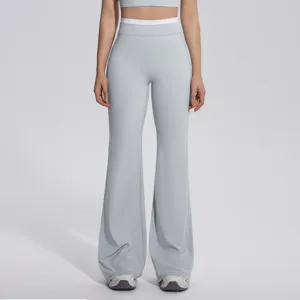 Pantalon de yoga évasé taille haute pour femme, avec ceinture contrastée et tissu très doux.