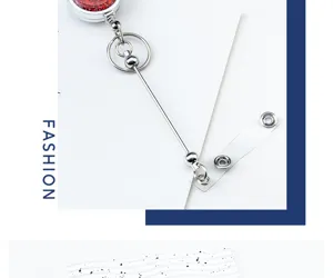 Close-up detail shot of the retractable badge reel showing shiny red glitter and sturdy metal links.