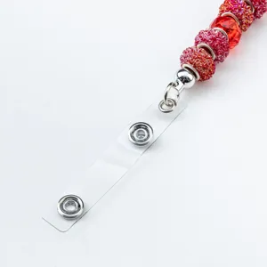 Red beaded lanyard badge holder strap with clear plastic strap and metal snap buttons.