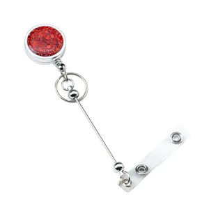 Retractable badge reel with red glitter design, metal chain and clear ID strap for nurse.