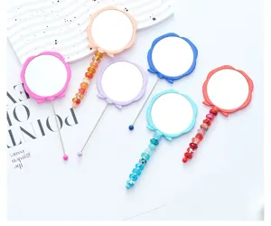 Detailed view of DIY rose flower handheld makeup mirror with beaded handle, portable and cute.