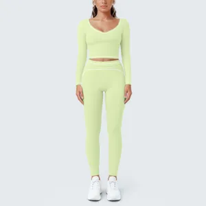 Light green long sleeve crop top and leggings yoga set featuring stylish white contrast trim details.