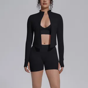 Seamless black 3-piece athletic yoga set featuring long sleeve zip jacket crop top and shorts.