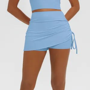 Close-up detail of light blue high waist ruched fake two-piece athletic yoga skort.