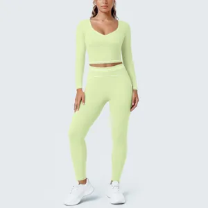 Detailed view of the pastel green long sleeve crop top and leggings fitness yoga set with contrast trim.