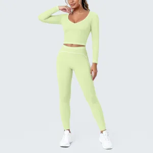 Women's light green seamless long sleeve crop top and high waist yoga leggings activewear set.