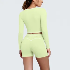 Back view close-up of light green long sleeve crop top and matching yoga shorts set details.