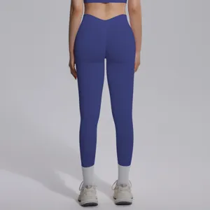 Back view detail of seamless high-waist push-up yoga leggings in solid blue color.