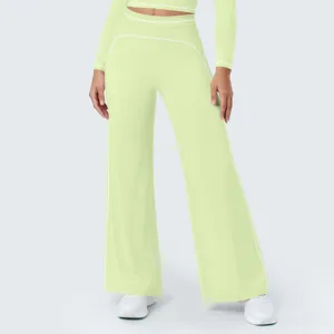 Light green high waist wide leg pants detail showing white contrast piping and fabric.