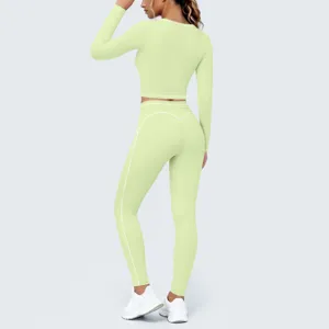Back detail view of light green long sleeve crop top yoga set with contrast piping for fitness.