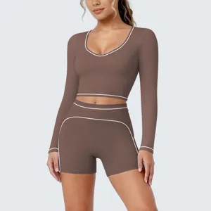 Details of women long sleeve crop top and shorts activewear set with contrast white piping.