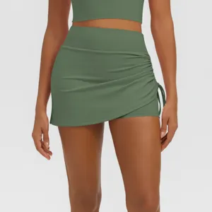 Green ruched athletic skirt detail, high waist fitness skort for running and yoga workout.