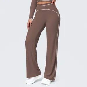 Detail shot of high waisted contrast piping wide leg pants and top activewear set brown.