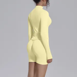 Detail view of light yellow seamless athletic top and matching high waist shorts set.