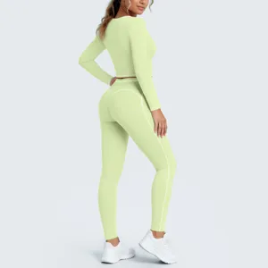 Detailed view of light green athletic crop top and leggings set with contrast piping.